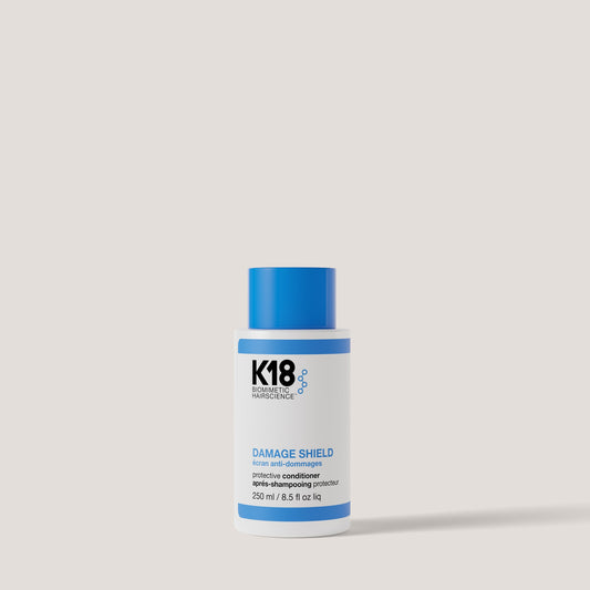 K18 Damage Shield Protective Conditioner 250ml on grey background