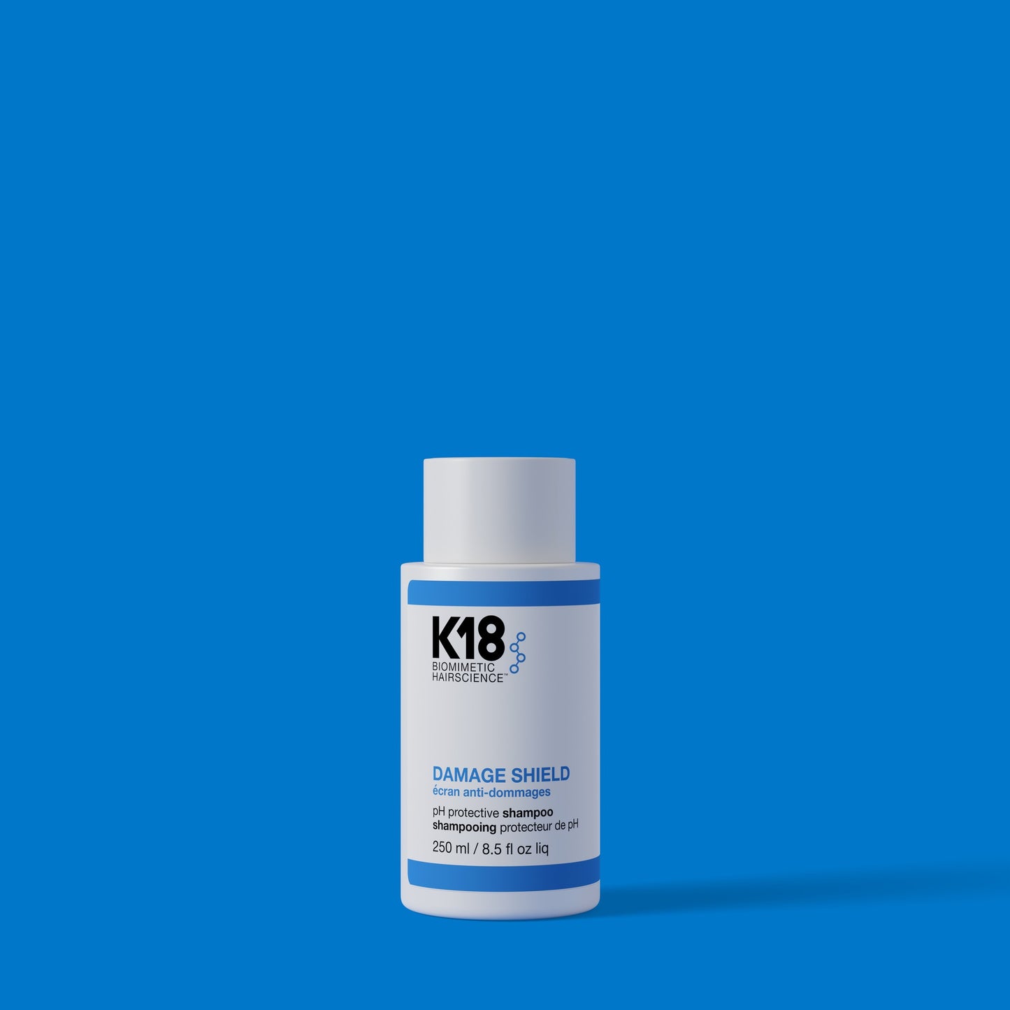 K18 Damage Shield pH Protective Shampoo 250ml on blue background