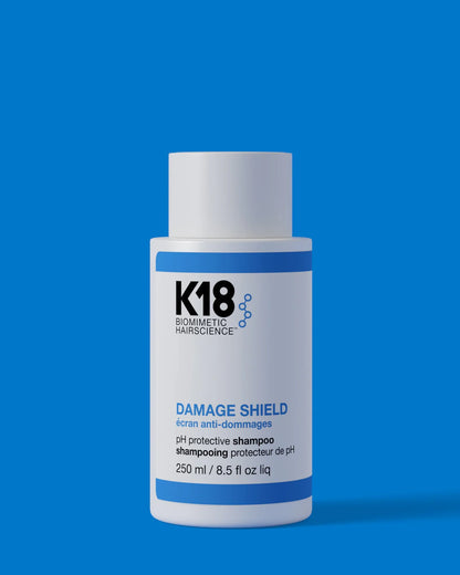 K18 Damage Shield pH Protective Shampoo 250ml on blue background