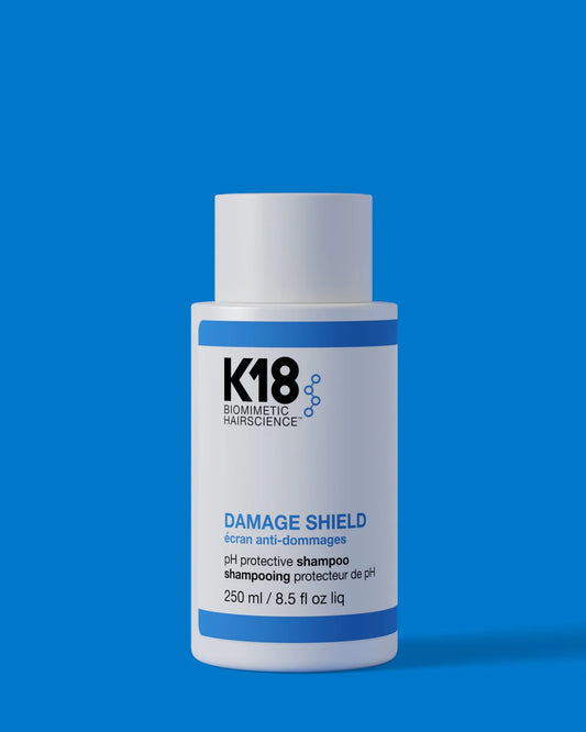 K18 Damage Shield pH Protective Shampoo 250ml on blue background